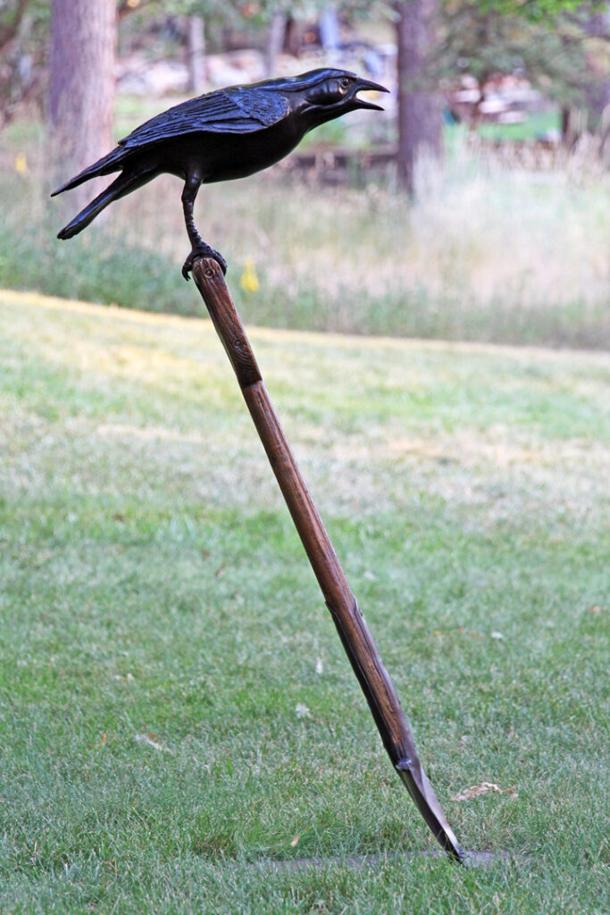 Bronze Crow on an antique garden shovel